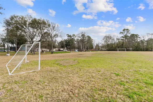 a view of a field with an trees in the background