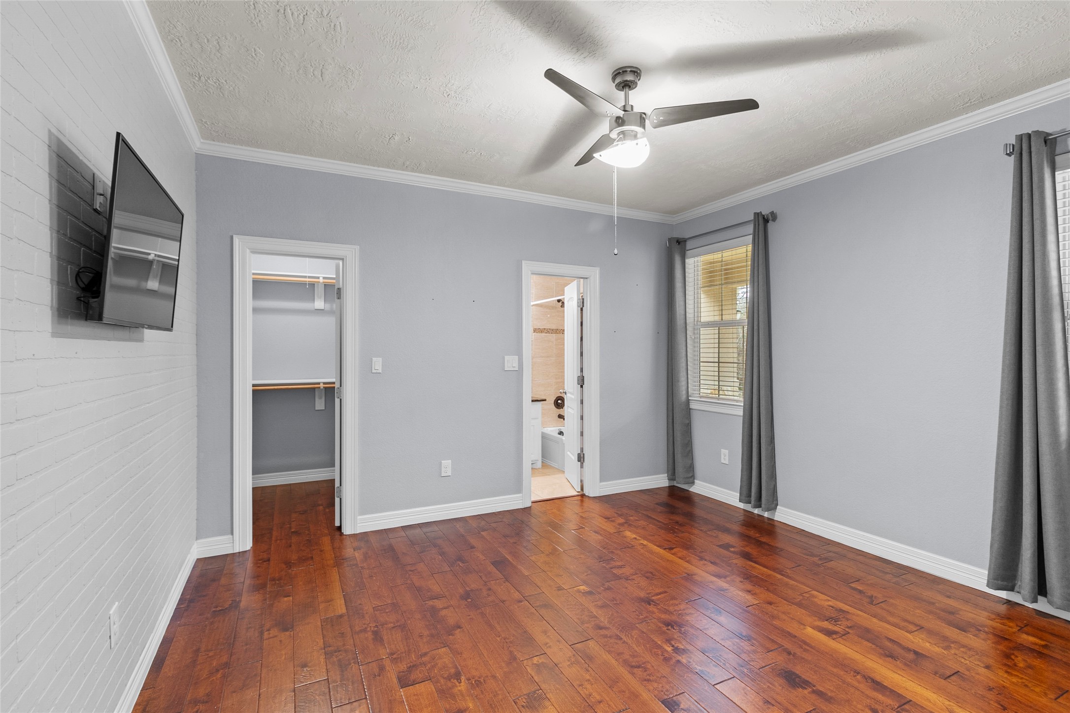 22321 Mossy Oaks Road Spring, TX 77389 - Photo 7 of 50 a view of empty room with wooden floor and fan