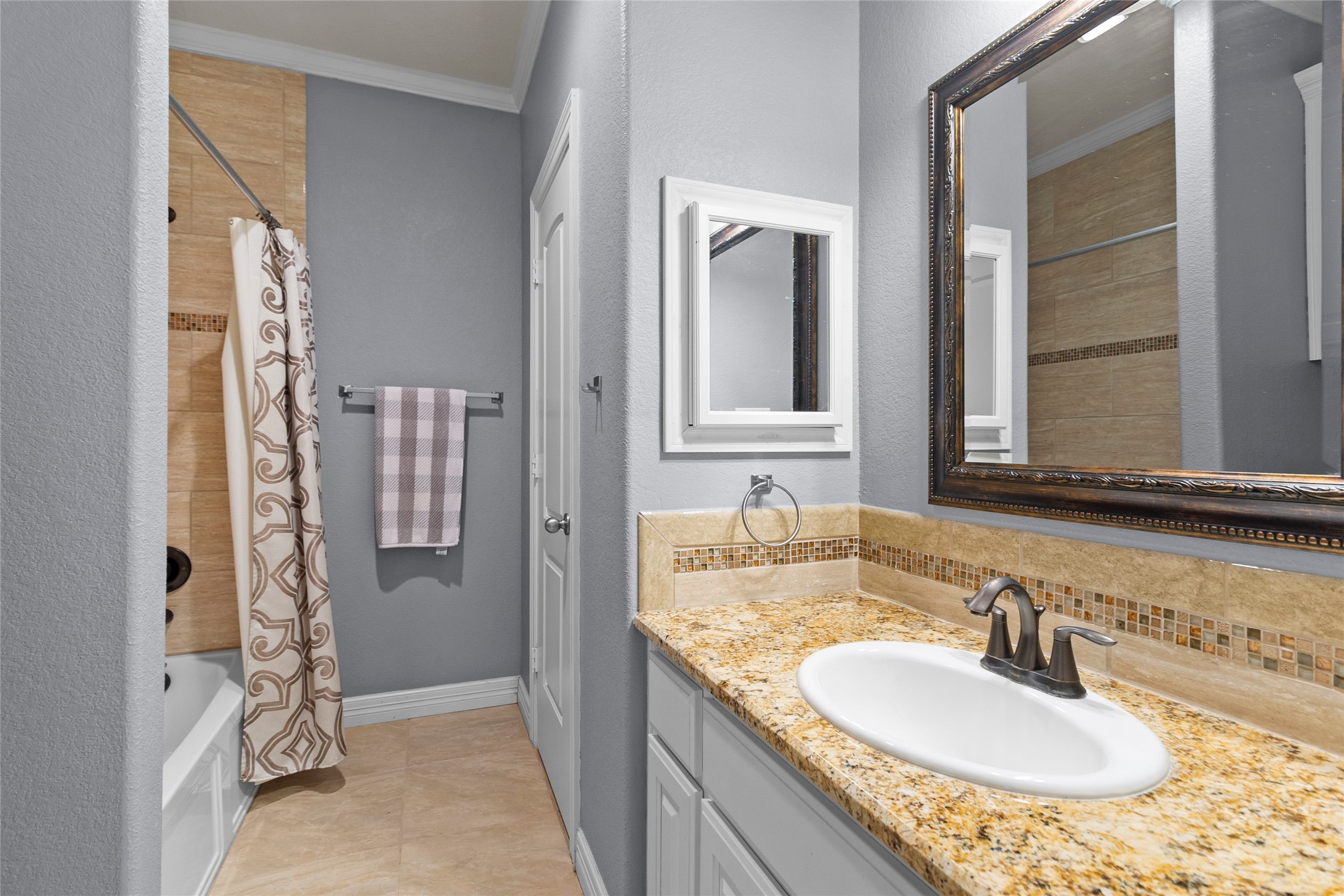 22321 Mossy Oaks Road Spring, TX 77389 - Photo 10 of 50 a bathroom with a granite countertop sink and a mirror