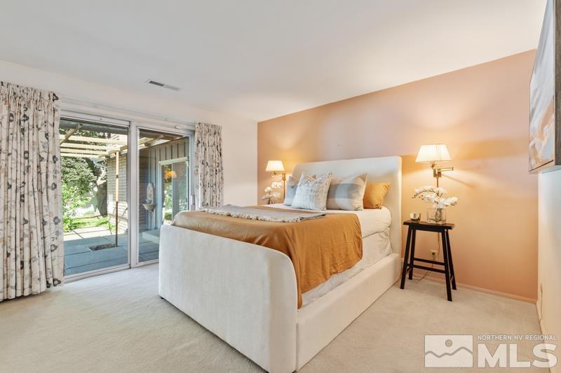 2301 Crescent Circle Reno, NV 89509 - Photo 17 of 40 a bedroom with a large bed and a night stand
