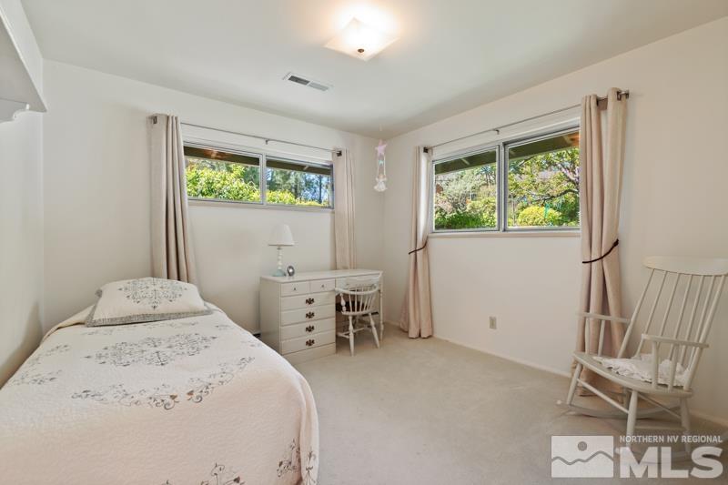 2301 Crescent Circle Reno, NV 89509 - Photo 24 of 40 a bedroom with a bed and a table