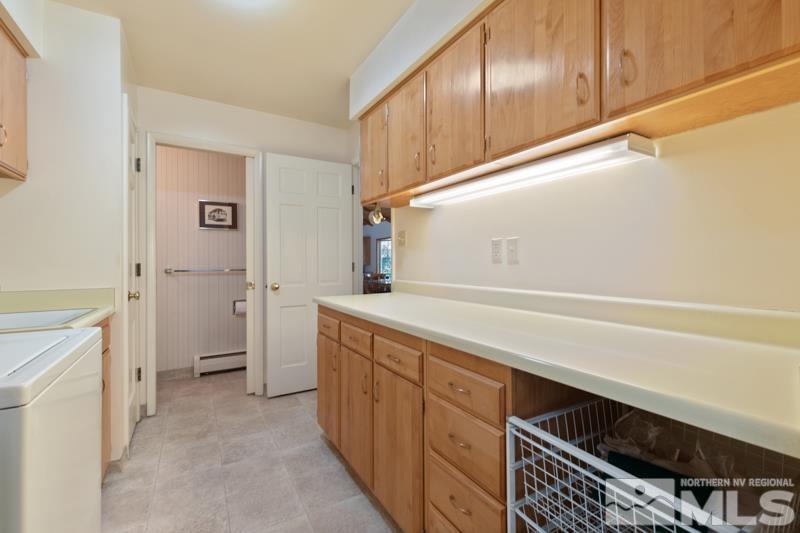 2301 Crescent Circle Reno, NV 89509 - Photo 27 of 40 a utility room with cabinets washer and dryer