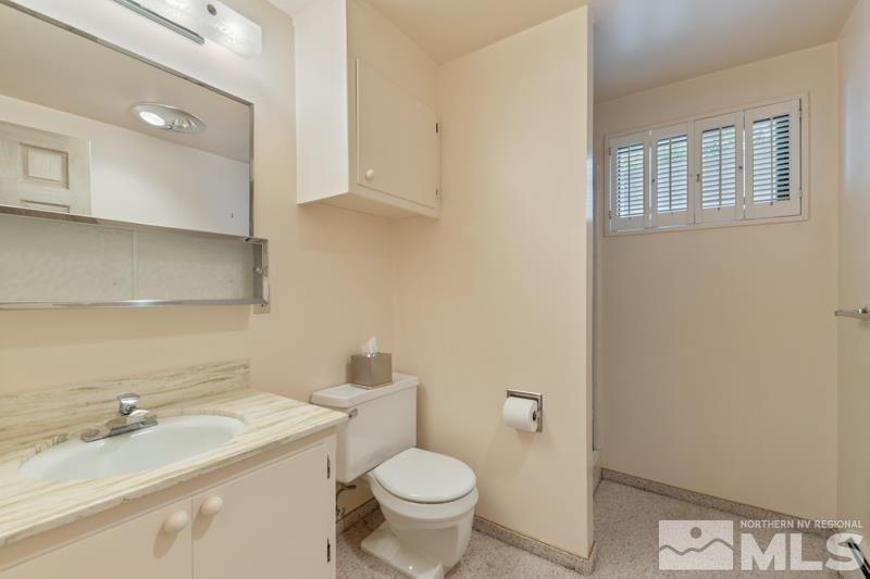 2301 Crescent Circle Reno, NV 89509 - Photo 34 of 40 a bathroom with a granite countertop toilet and sink