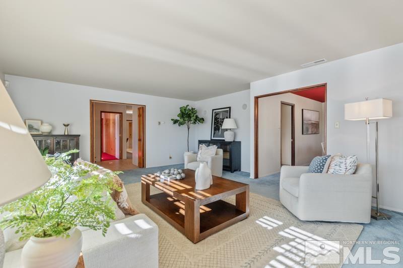 2301 Crescent Circle Reno, NV 89509 - Photo 5 of 40 a living room with furniture and a chandelier