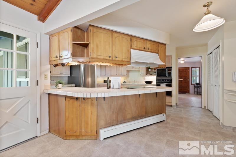 2301 Crescent Circle Reno, NV 89509 - Photo 10 of 40 a kitchen with stainless steel appliances granite countertop a stove a sink and a refrigerator