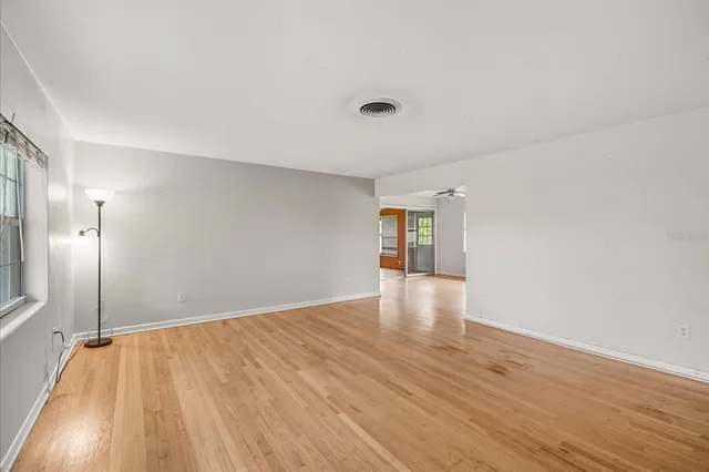 wooden floor in an empty room with a window