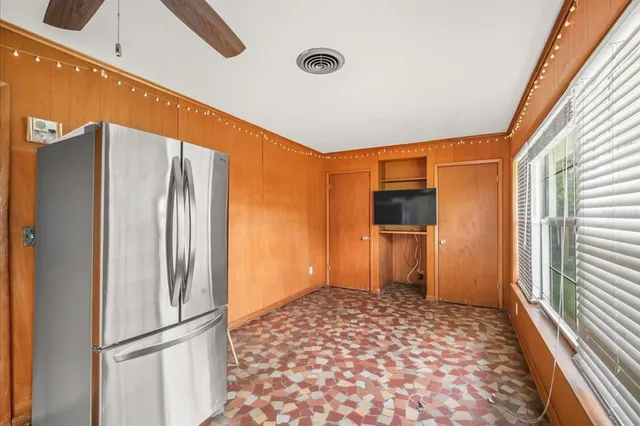 a kitchen with a refrigerator and a sink