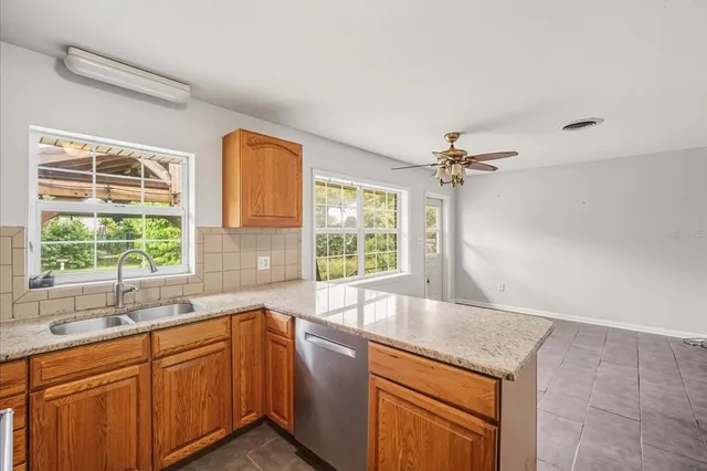 a kitchen with granite countertop a sink and a window