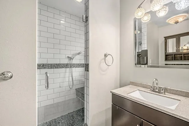 a bathroom with a shower and a sink