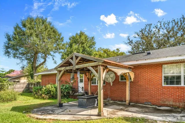 a view of a blue house with a yard
