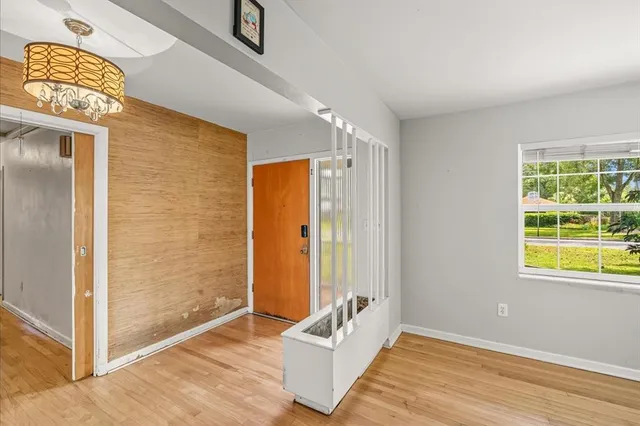 a view of an entryway with wooden floor and door