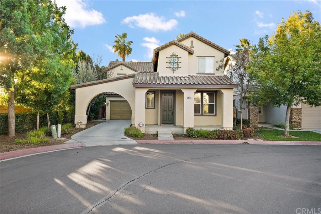 4591 Sandano Street Riverside, CA 92507 - Photo 1 of 1 a front view of a house with a garden and a garage