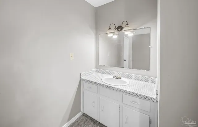 a bathroom with a sink and mirror