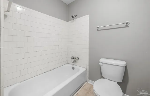 a bathroom with a toilet a sink and bathtub