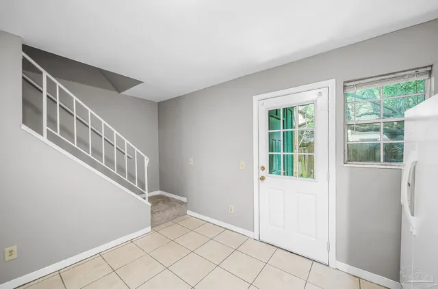 a view of an entryway with wooden floor