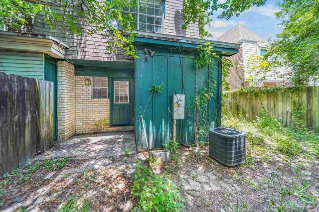 a view of a backyard with plants and outdoor seating