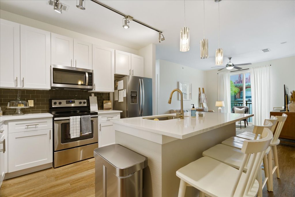 1900 Barton Springs Road, Unit 4029 Austin, TX 78704 - Photo 1 of 21 Modern cabinetry and a central prep island anchor this functional open kitchen space.