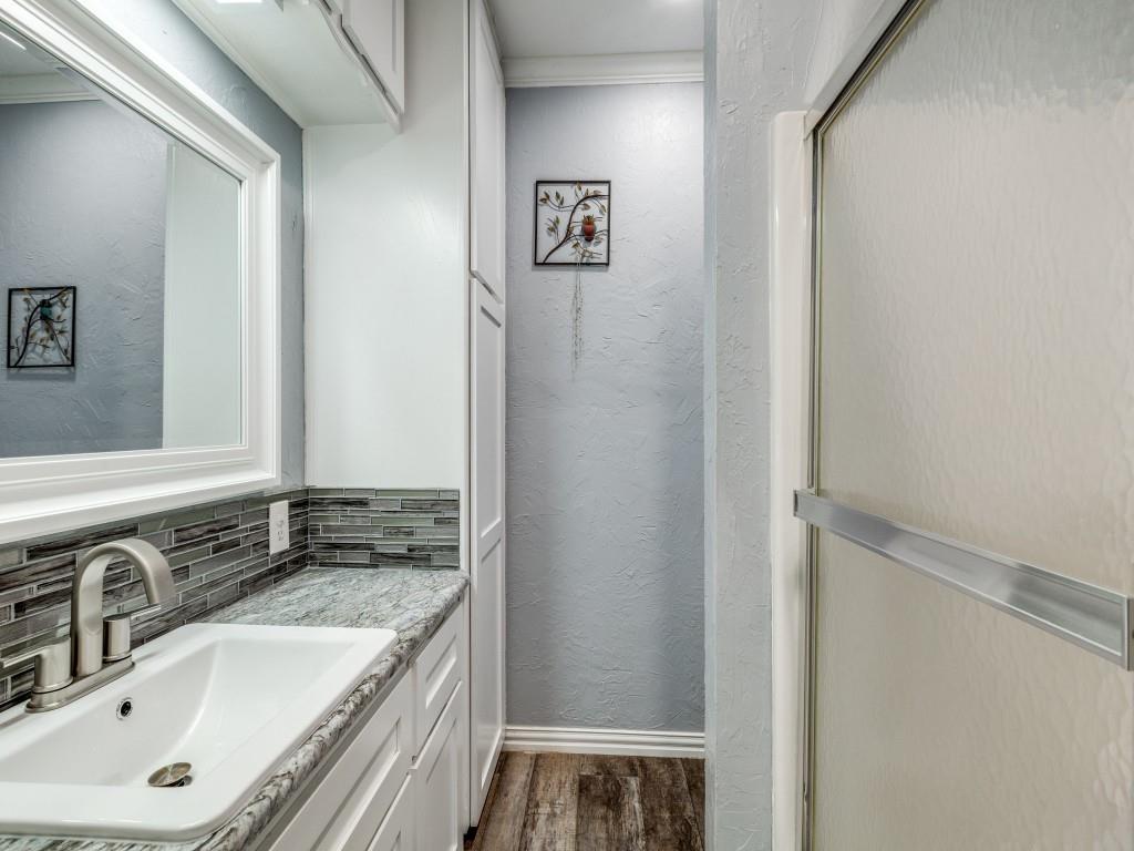 3061 Turkey Creek Road Sunset, TX 76270 - Photo 13 of 31 a bathroom with a granite countertop sink and a mirror