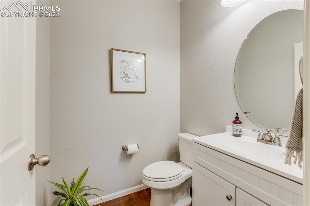 7122 Golden Acacia Lane Colorado Springs, CO 80927 - Photo 13 of 37 a bathroom with a sink mirror and toilet