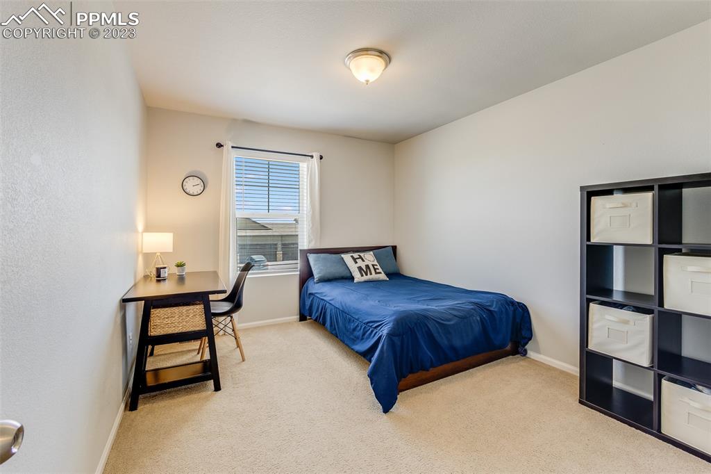 7122 Golden Acacia Lane Colorado Springs, CO 80927 - Photo 25 of 37 a bedroom with a bed and a window