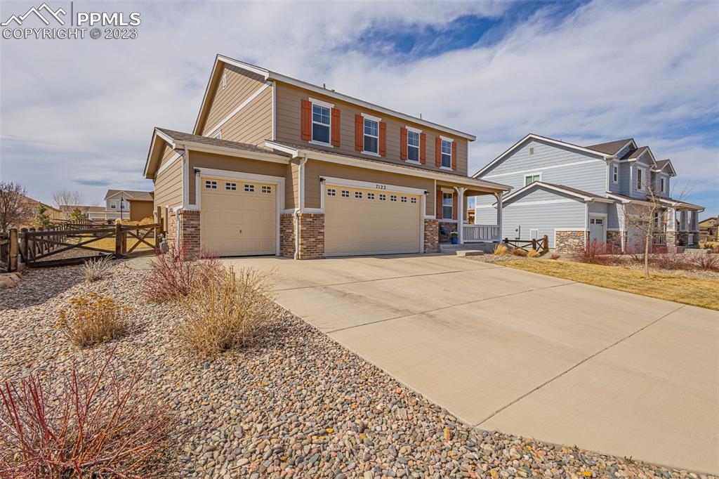 7122 Golden Acacia Lane Colorado Springs, CO 80927 - Photo 3 of 37 a front view of a house with a yard