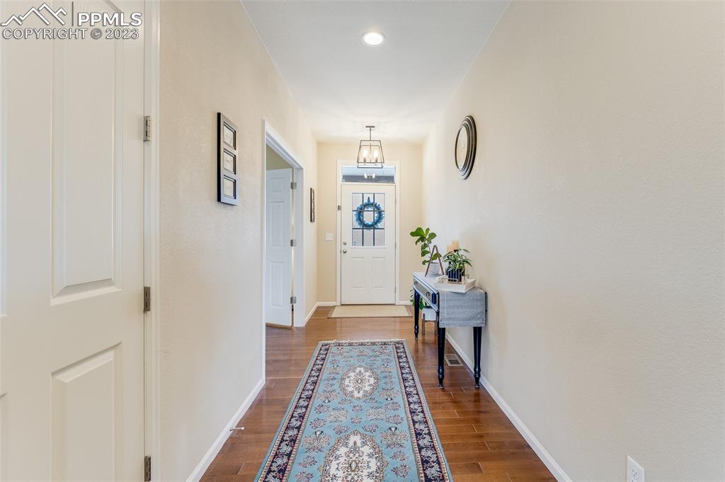 7122 Golden Acacia Lane Colorado Springs, CO 80927 - Photo 4 of 37 a view of hallway with wooden floor