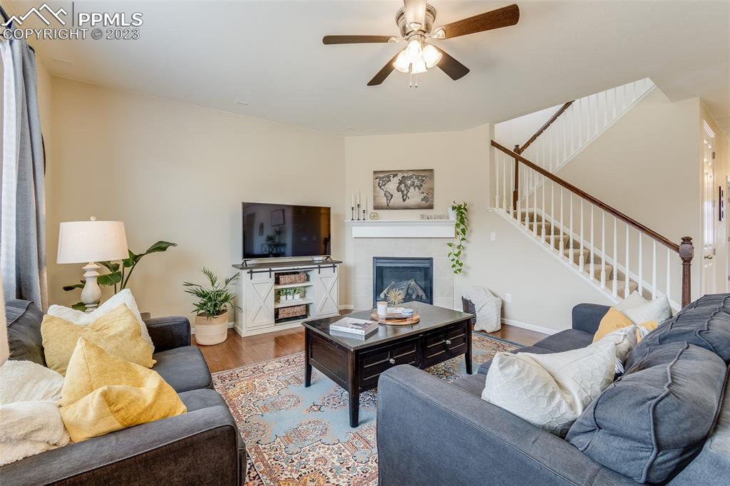 7122 Golden Acacia Lane Colorado Springs, CO 80927 - Photo 6 of 37 a living room with furniture a flat screen tv and a fireplace