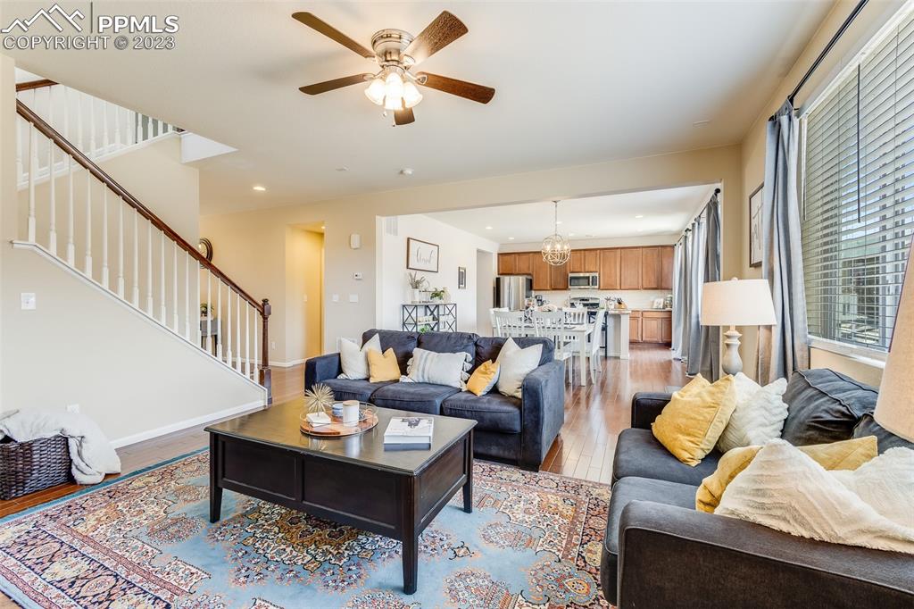 7122 Golden Acacia Lane Colorado Springs, CO 80927 - Photo 7 of 37 a living room with furniture and a chandelier