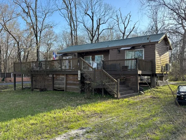 a view of a house with a yard and sitting area