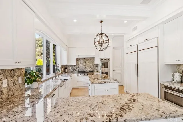 a view of a patio with a table and chairs under an umbrella
