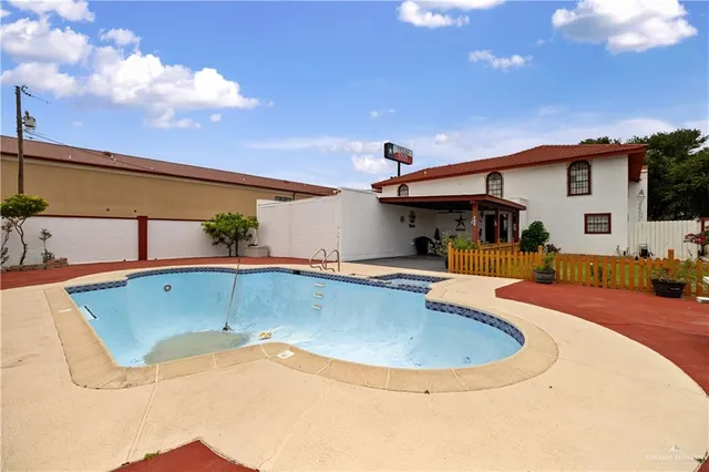 a view of a swimming pool with a yard