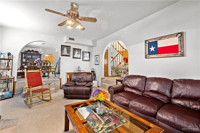 a living room with furniture a rug and a chandelier