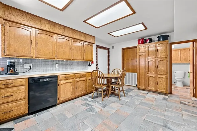 a kitchen with stainless steel appliances granite countertop a sink and cabinets