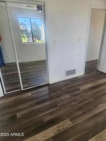 a view of hallway with wooden floor