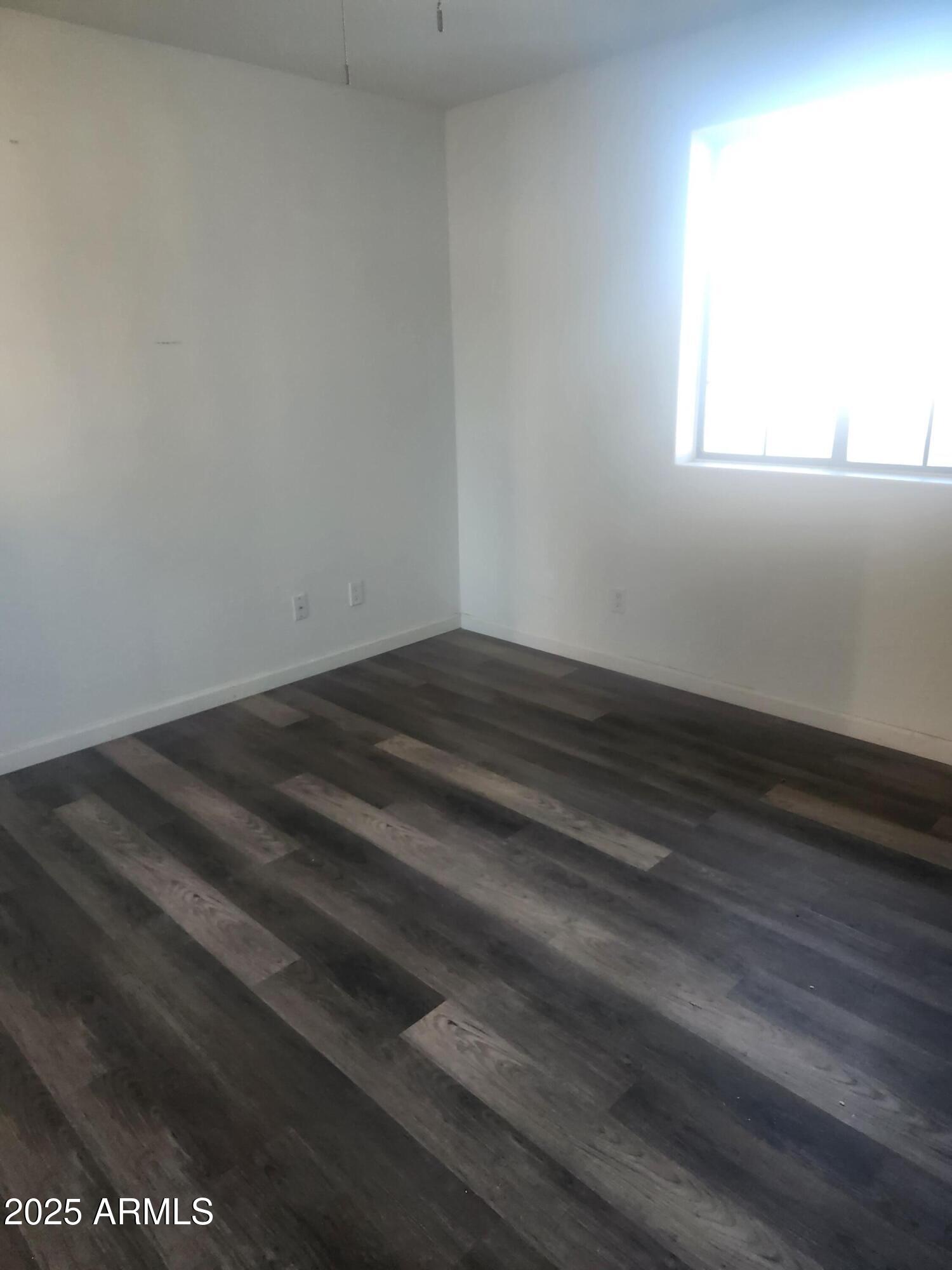 1940 East 13th Street Douglas, AZ 85607 - Photo 14 of 32 a view of room with wooden floor and window