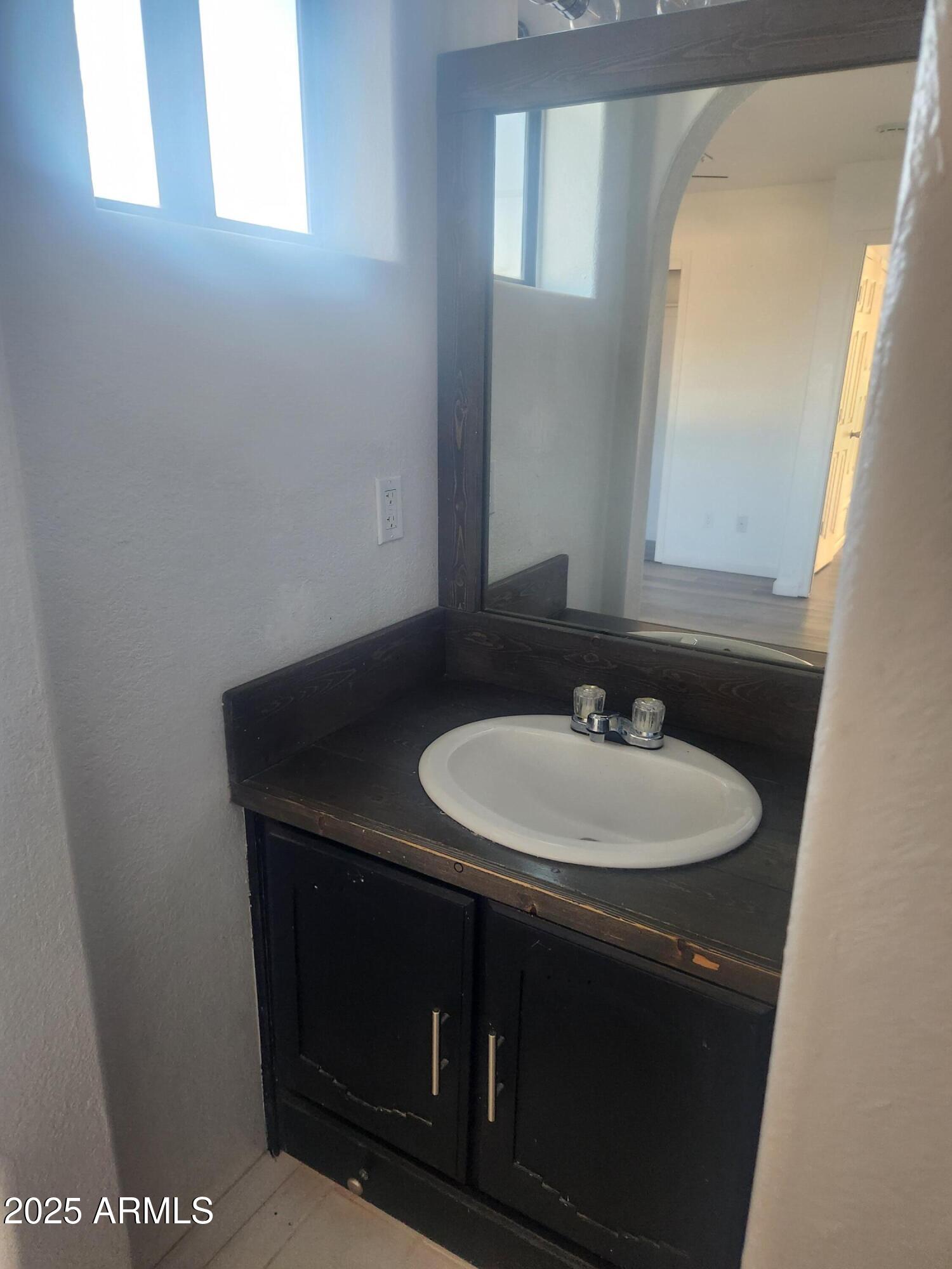 1940 East 13th Street Douglas, AZ 85607 - Photo 18 of 32 a bathroom with a sink and a mirror