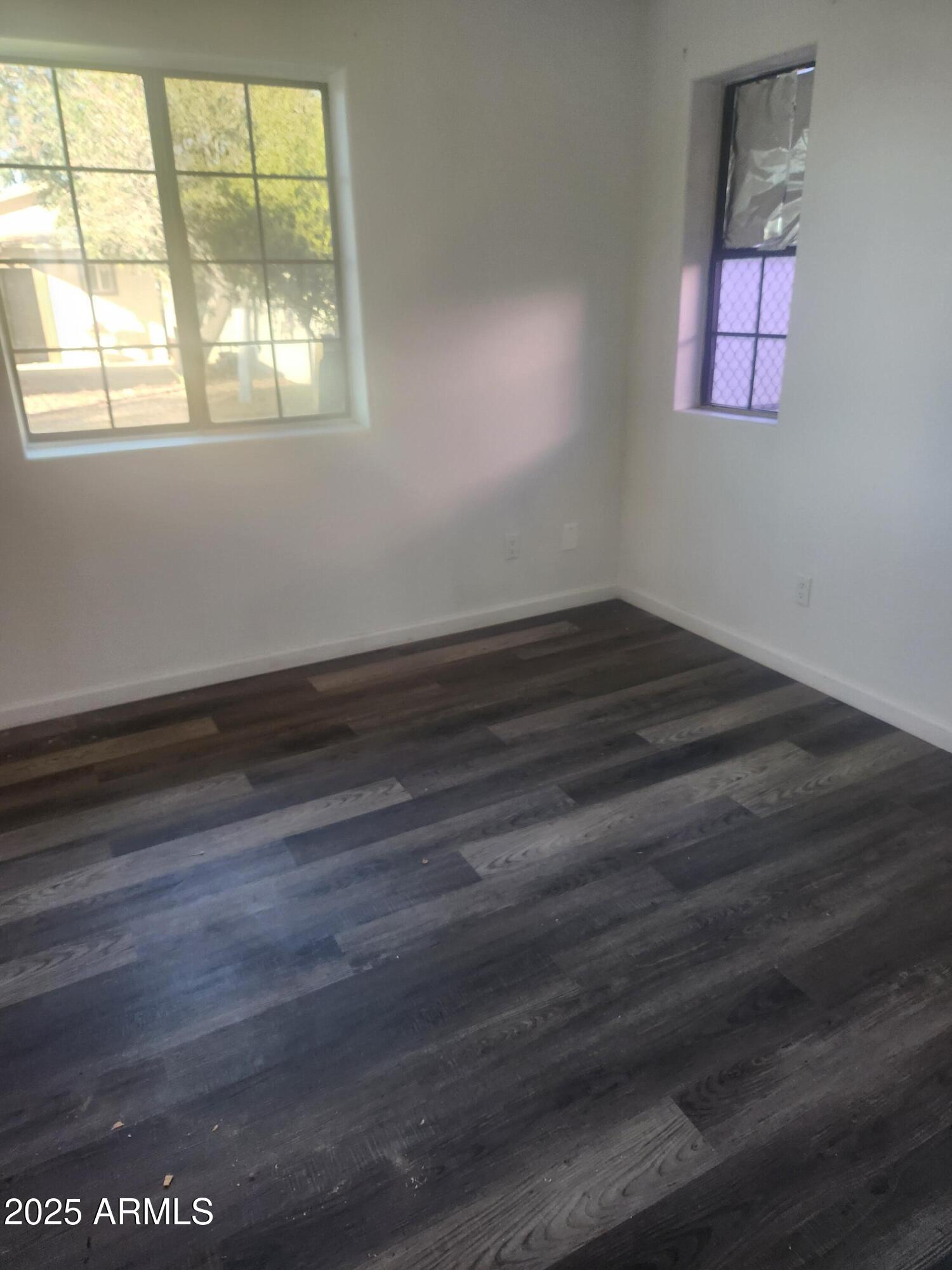 1940 East 13th Street Douglas, AZ 85607 - Photo 21 of 32 an empty room with wooden floor and windows
