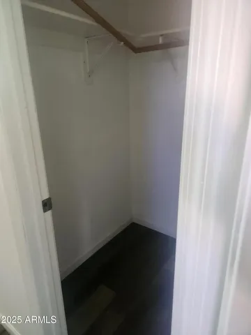 a white toilet sitting next to a white wall