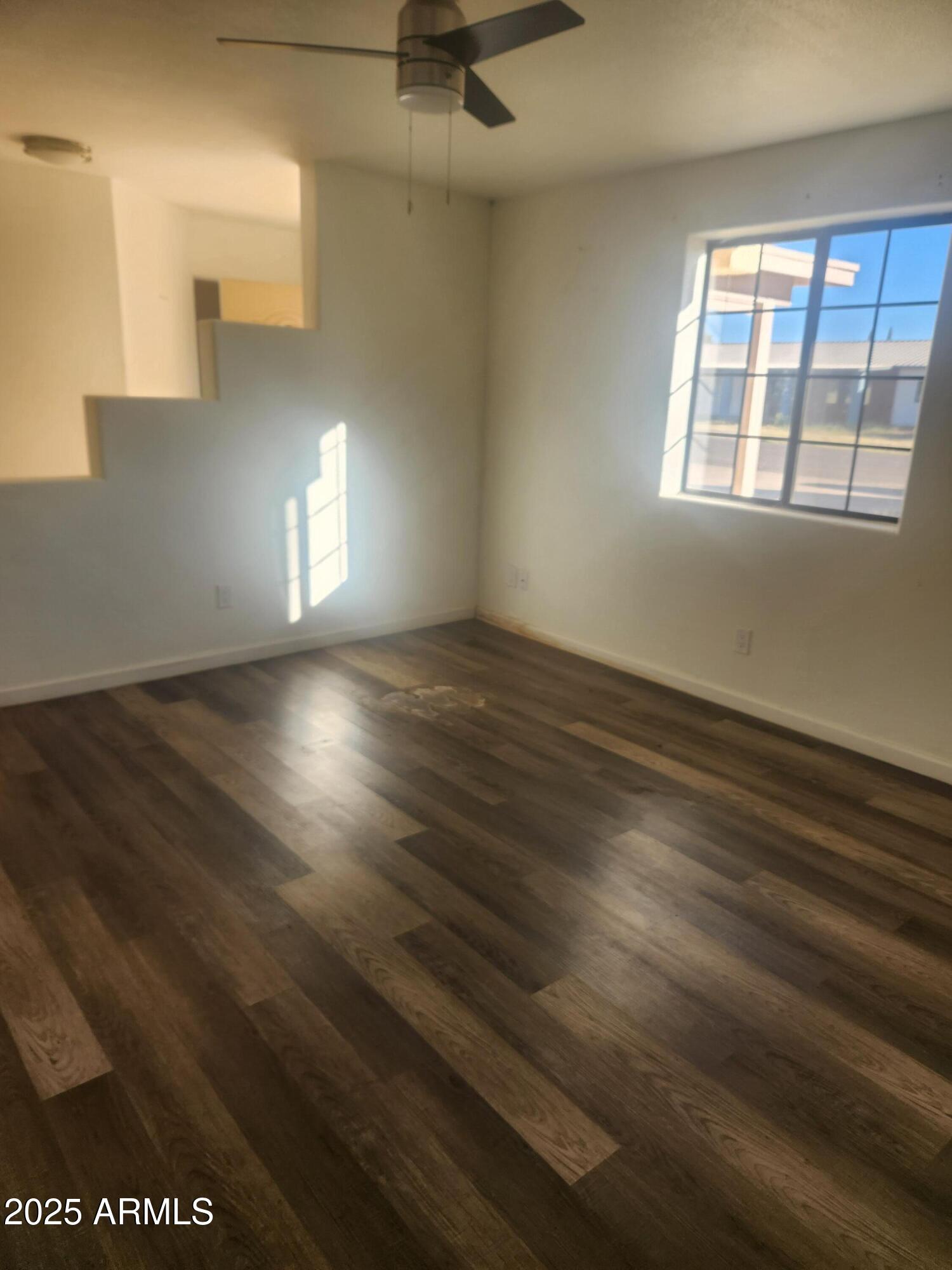 1940 East 13th Street Douglas, AZ 85607 - Photo 3 of 32 an empty room with wooden floor and windows
