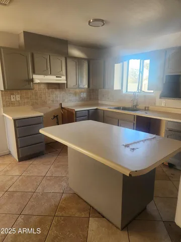 a kitchen with stainless steel appliances granite countertop a sink and a stove