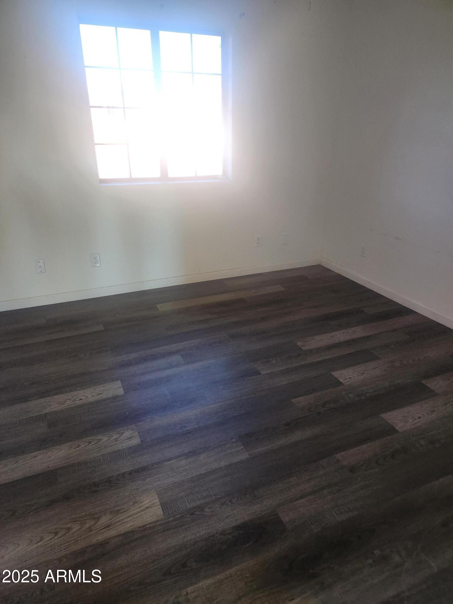 1940 East 13th Street Douglas, AZ 85607 - Photo 8 of 32 a view of empty room with wooden floor and fan