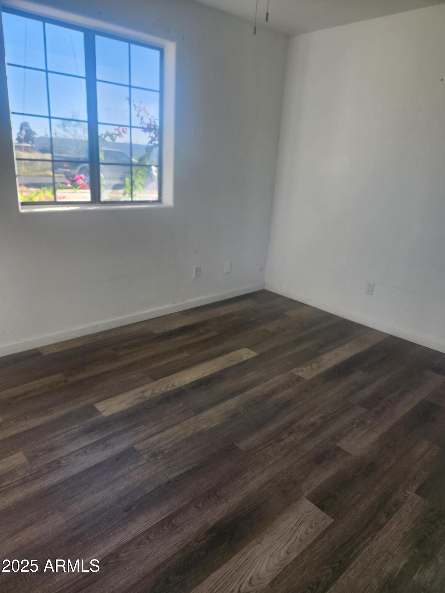 1940 East 13th Street Douglas, AZ 85607 - Photo 10 of 32 an empty room with wooden floor and windows