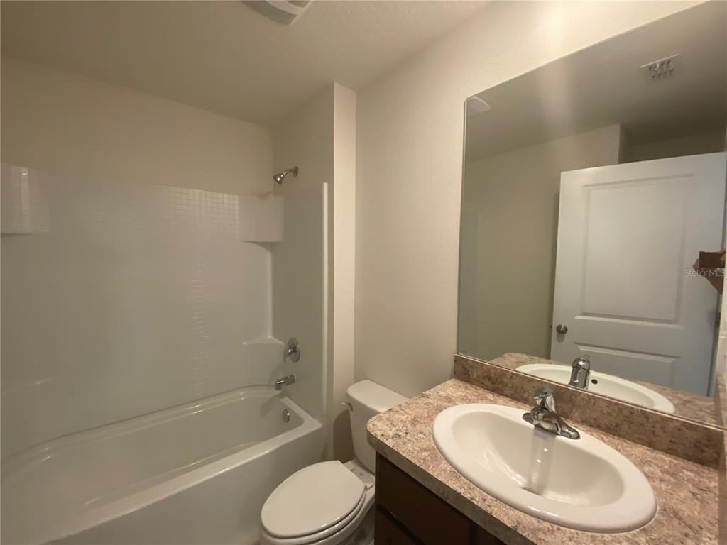 308 Hickory Course Radiel Ocala, FL 34472 - Photo 19 of 24 a bathroom with a granite countertop sink toilet and shower