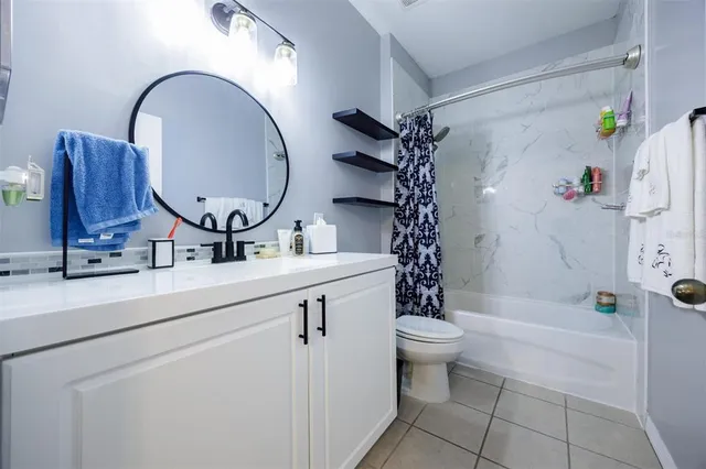 a bathroom with a bathtub a toilet and a shower