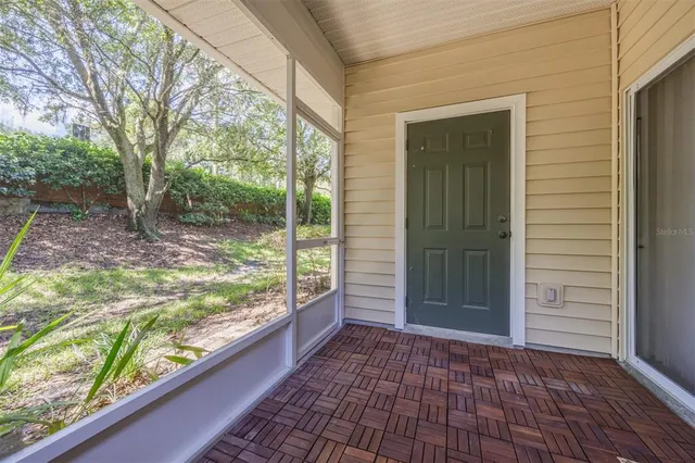 an aerial view of a house with swimming pool and a yard