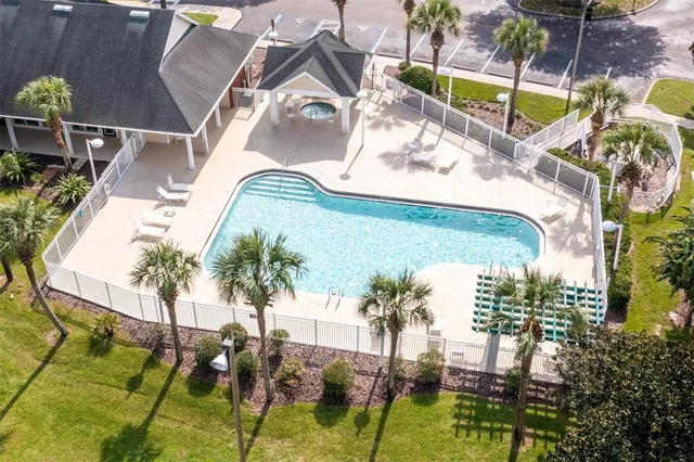 an aerial view of a tennis ground and a house