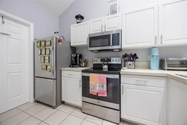 a kitchen with a refrigerator and cabinets