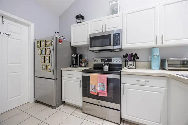 a kitchen with a refrigerator and cabinets