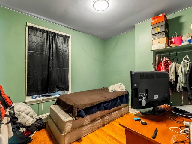 a bed room with a bed and a television