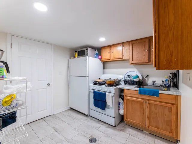a kitchen with sink a stove and refrigerator